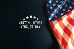 an image of a United States Flag and notice of MLK Holiday